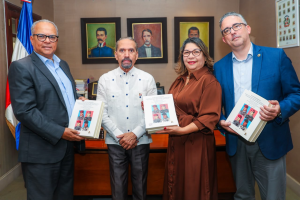 Representantes de Efemérides Patrias y UNAPEC posan con ejemplares del libro Ajusticiamiento de Trujillo.